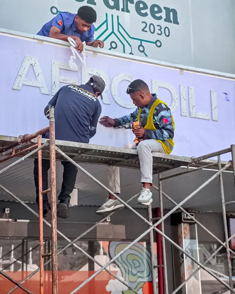 Shop-front signage installation — Planet Printing, Dili