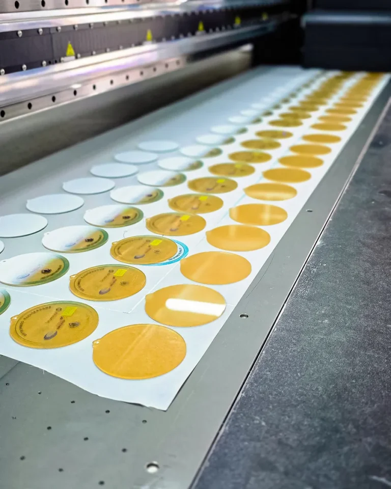 UV-printed round labels on the bed — Planet Printing, Dili